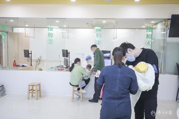 家长有序间隔一定距离,排队接种。/王伟楠摄