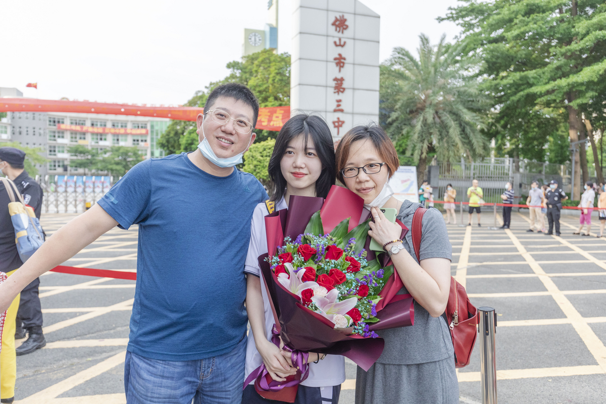考生和家长在佛山三中门口合影留念。图/佛山日报记者 王伟楠摄