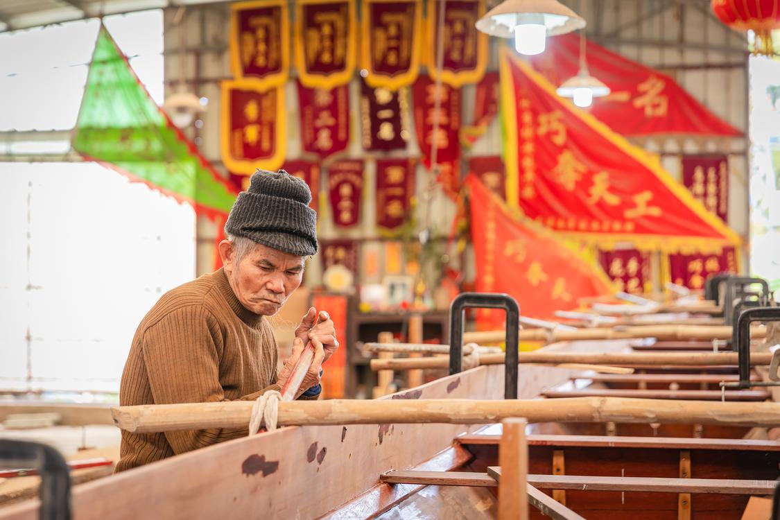 在三水西南街道显学村的李氏船厂,李保安正在对龙舟进行加工,李保安今年86岁,是目前三水年龄最大的龙舟匠人。佛山日报记者王澍摄.jpg