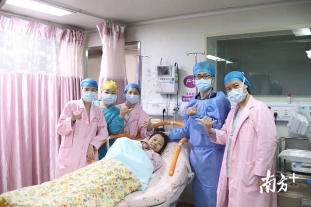 广东医科大学顺德妇女儿童医院内,陪伴梁女士生产的丈夫王先生与值班医护人员,一起为梁女士的勇敢点赞。