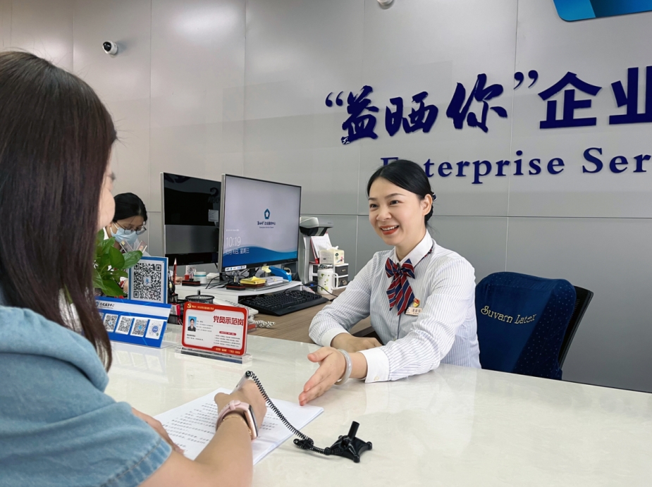 窗口党员谭颖仪正在耐心指引办事人填报资料.png