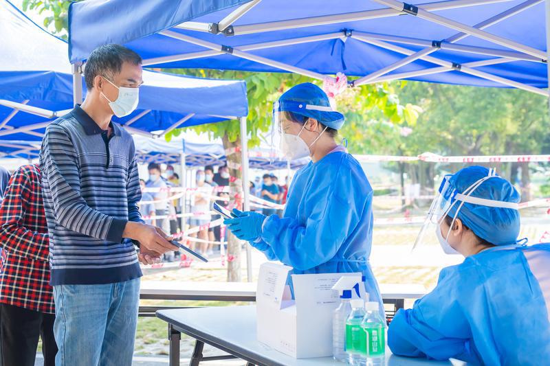 2022年10月28日,三水区开展全员核酸检测,白坭镇沙围村富景社区核酸采样点,党员志愿者正在登记信息,扫描市民的粤核酸码。/佛山日报记者王澍摄