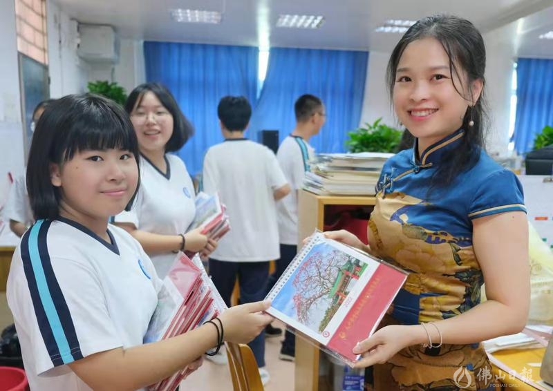 9月10日上午课间,九江中学团委学生会的学生干部将在暑假期间设计的九江中学定制台历送给老师们。祝老师们节日快乐。/佛山日报摄影俱乐部梁平摄