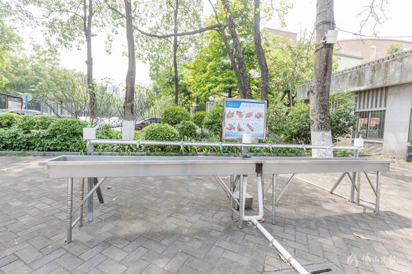 石门中学校门口设置了洗手台,返校的学生需要先洗手消毒再进入校园。佛山日报记者王伟楠摄