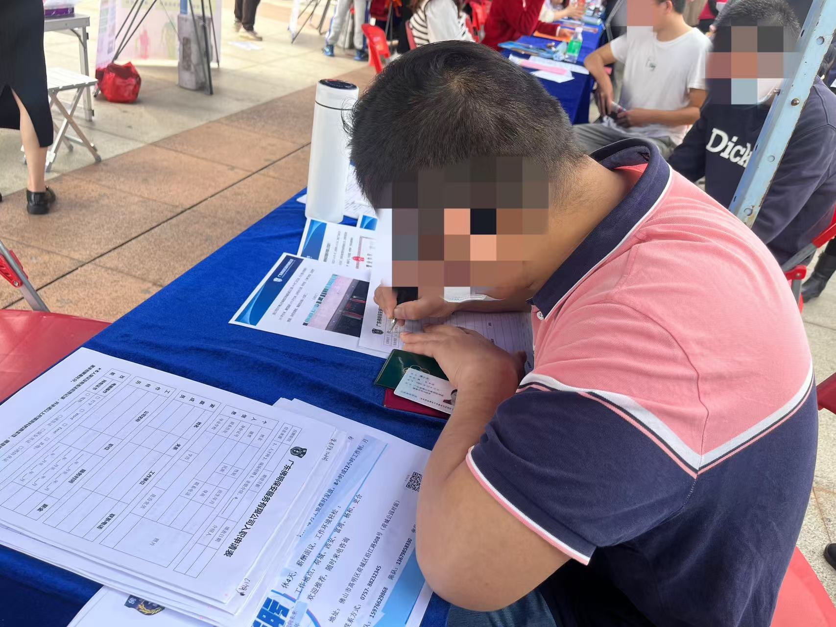 此前,一名残疾人在企业招聘摊位上填写应聘信息。资料图.jpg